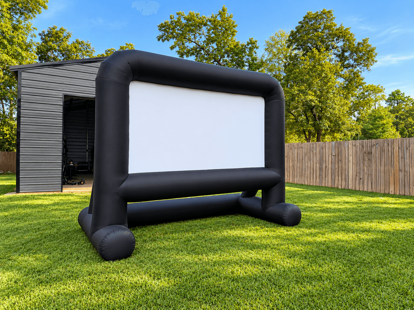 Outdoor inflatable movie screen set up on a lawn